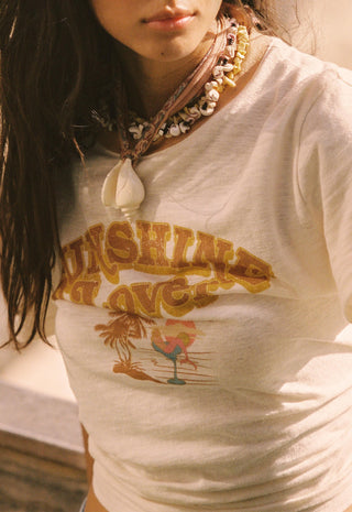  paired with denim shorts and layered necklaces