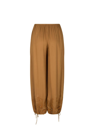 a-pair-of-loose-wide-leg-harem-style-pants-in-a-warm-camel-brown-color-featuring-a-gathered-elastic-waistband-and-drawstring-ankle-cuffs-with-embroidered-detailing-near-the-lower-hems-shown-against-a-plain-white-background