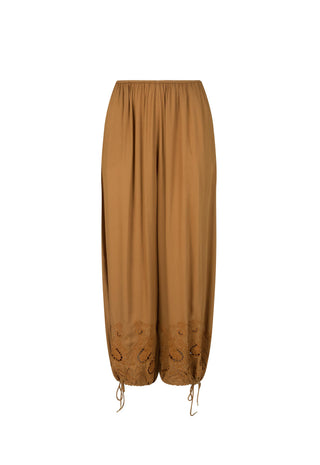 a-pair-of-loose-wide-leg-harem-style-pants-in-a-warm-camel-brown-color-featuring-gathered-elastic-waistband-and-drawstring-hems-with-embroidered-detailing-near-the-lower-legs-shown-against-a-plain-white-background