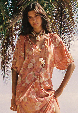  dusty pink floral dress with voluminous short sleeves and a draped neckline.