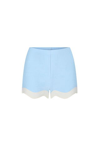 light-blue-knit-shorts-with-a-scalloped-cream-colored-hem-shown-flat-against-a-plain-white-background